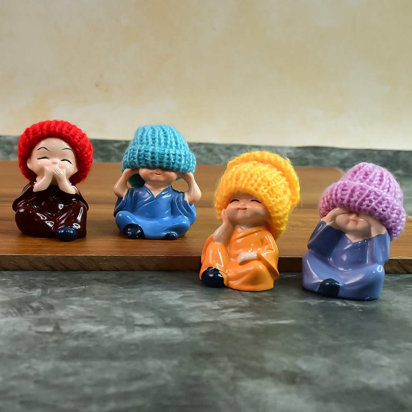 Resin Monk Buddha showpiece set featuring four figurines with traditional straw hats on a white background