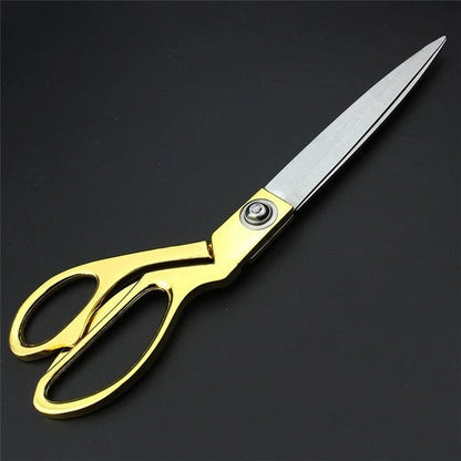 Professional golden tailoring scissors for precise fabric cuts.