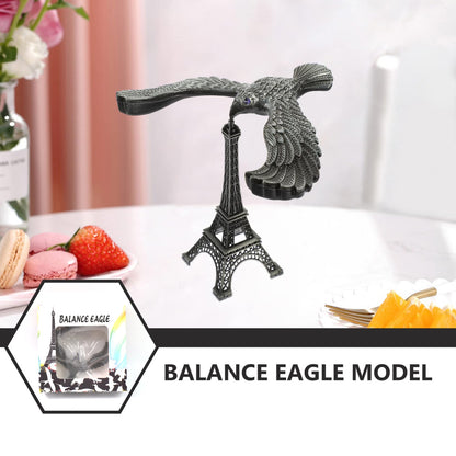 The gravity-defying metal bird statue with its Eiffel Tower base, presented as an elegant home decor item.
