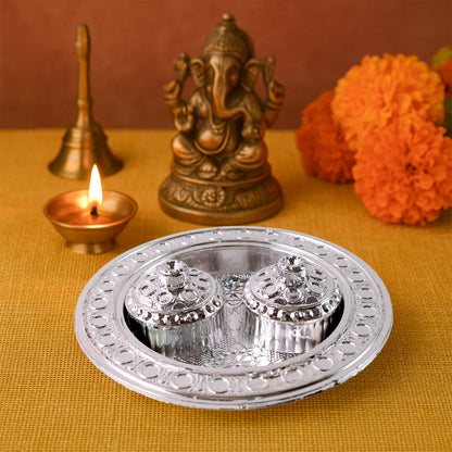 The round Kumkum Thali Holder displayed elegantly on a traditional Indian cloth.