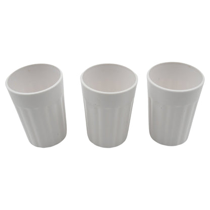 Multiple small plastic coffee and tea cups arranged for display.