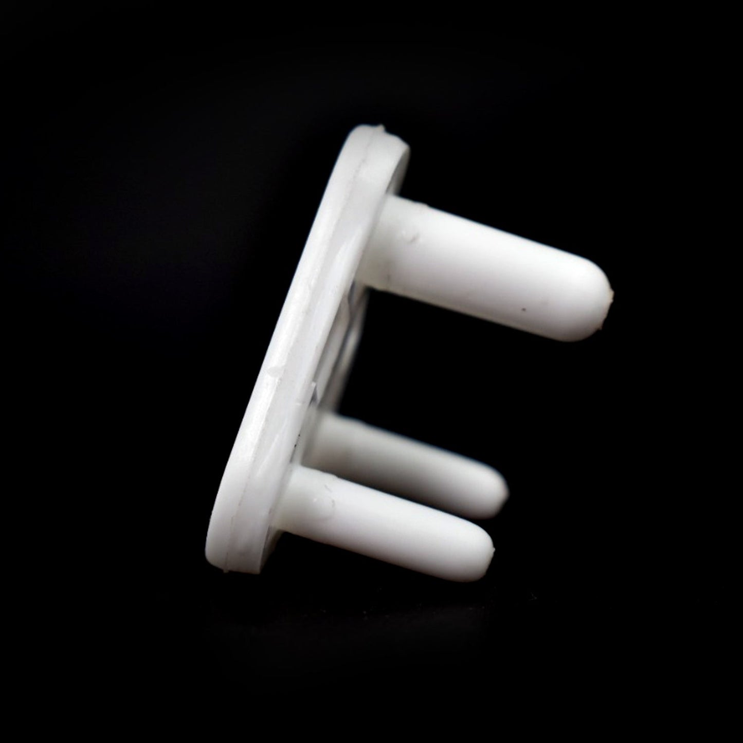 Overhead view of several baby socket covers, showcasing their simple and effective design.