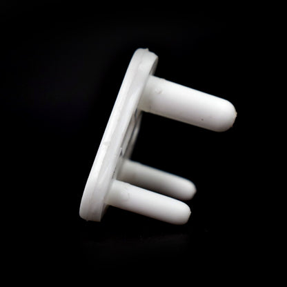 Overhead view of several baby socket covers, showcasing their simple and effective design.
