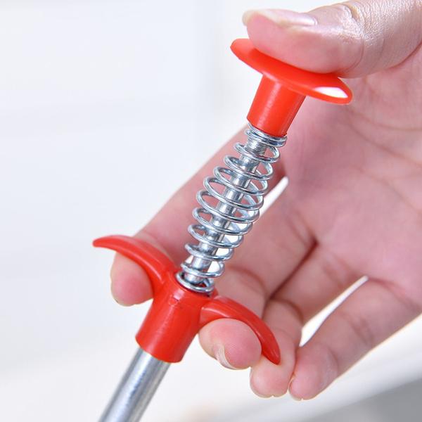 The grabber end of the drain cleaning brush for removing hair and debris.