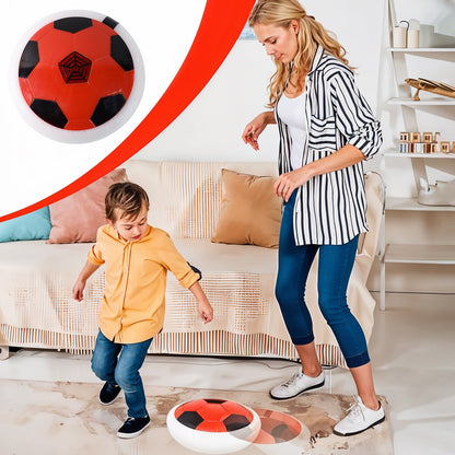 Child playing with soft kick hover soccer ball indoors