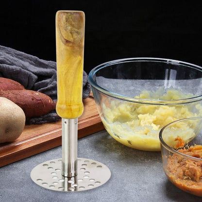 Stainless Steel Potato Masher resting beside a bowl of freshly mashed potatoes.