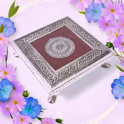 Decorative silver patla with a beautiful lotus blossom motif for traditional Indian pooja.