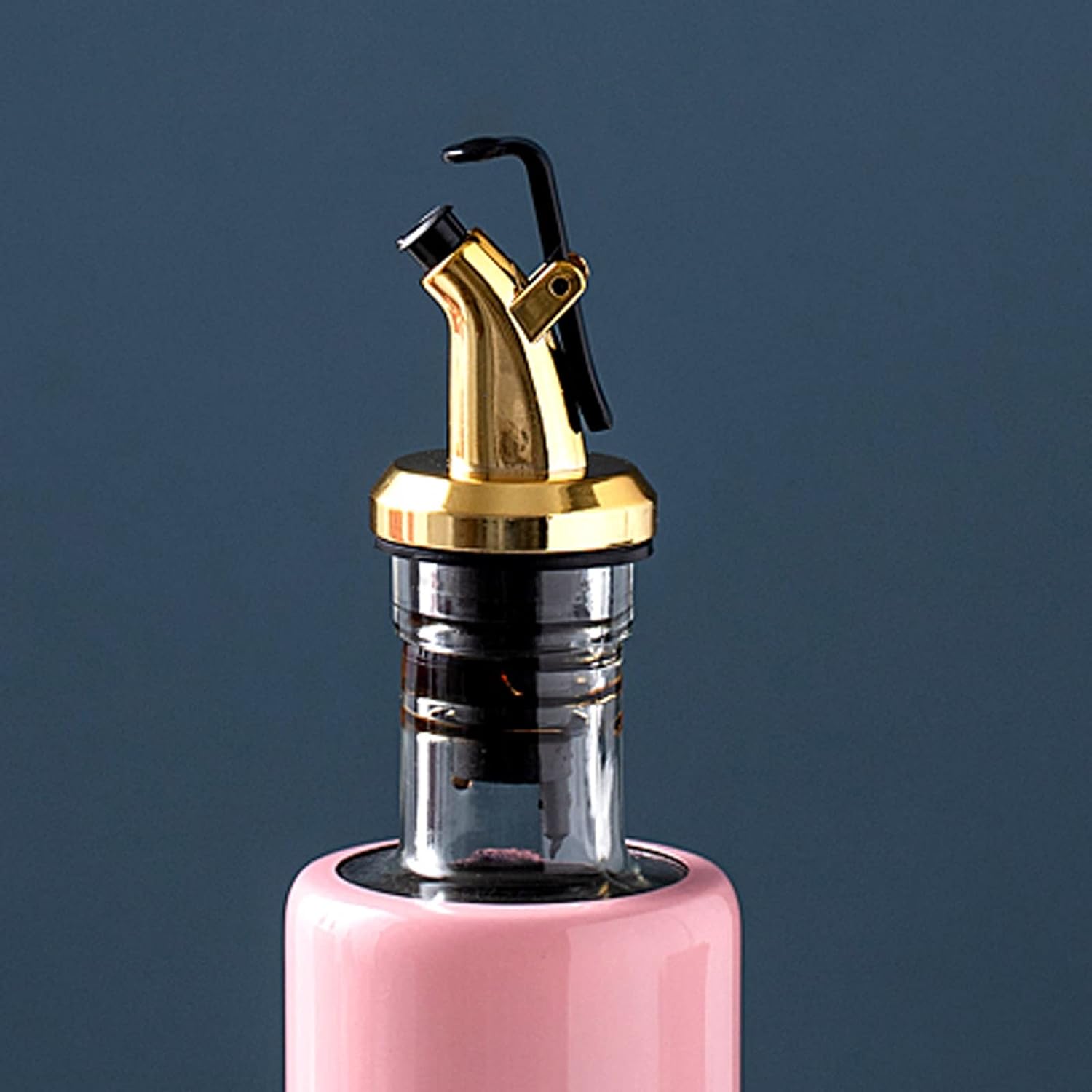 The 300ml olive oil dispenser displayed with various condiments like soy sauce and vinegar, highlighting its versatility.
