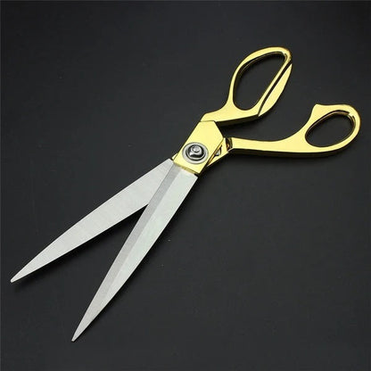 Golden handle cloth cutting scissors with sharp blades.