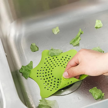 Starfish-shaped silicone drain strainer effectively catching debris in a kitchen sink.