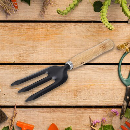 The versatile hand weeding fork posed in a garden bed, perfect for planting and transplanting.