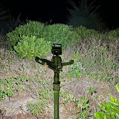 Person using a compact keychain flashlight for outdoor activities