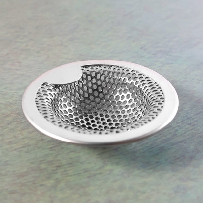Kitchen sink strainer showing rust-resistant steel surface and holes