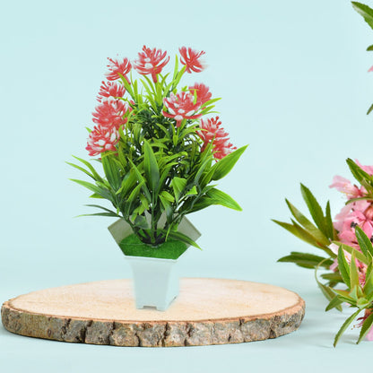 A realistic artificial flower plant with green leaves and pink blossoms in a white pot, perfect for home decor.