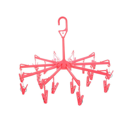Close-up of the clothes clips hanger securely holding baby clothes for quick drying.