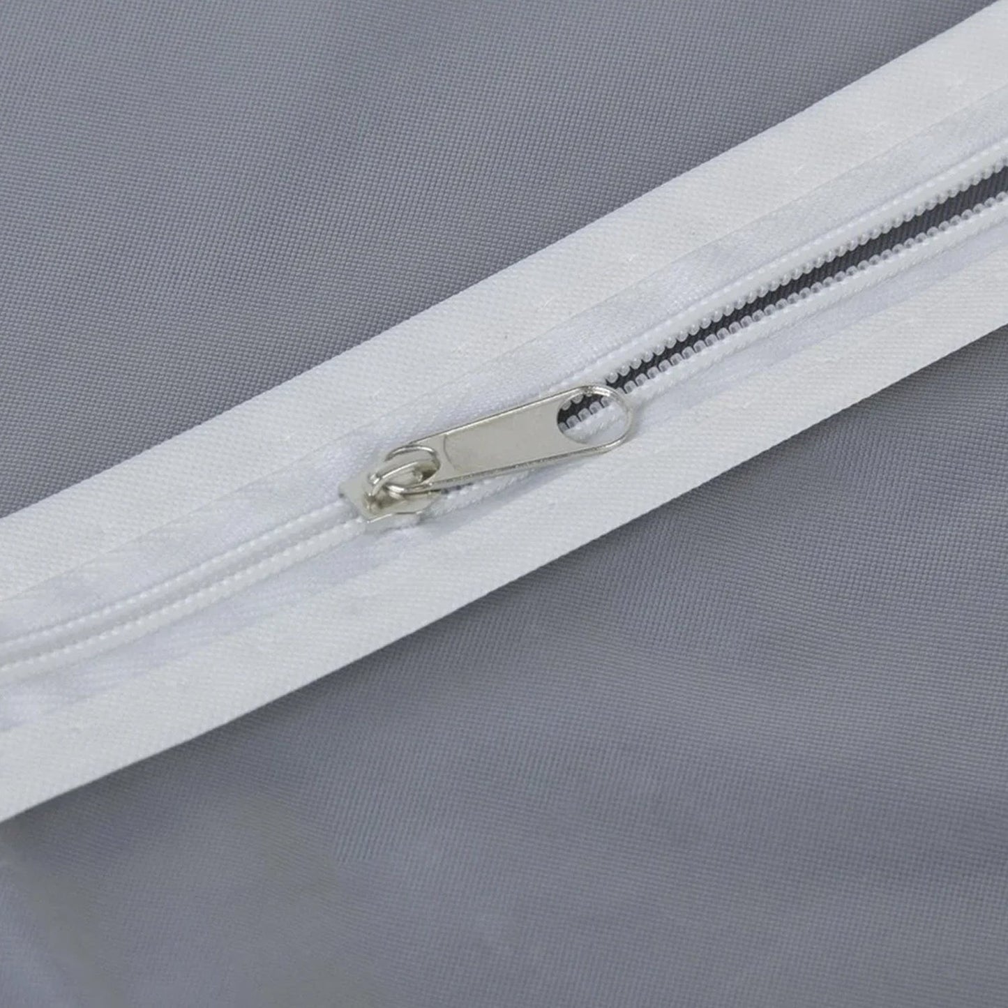 Closeup of durable full-length zipper on the breathable fabric suit cover.