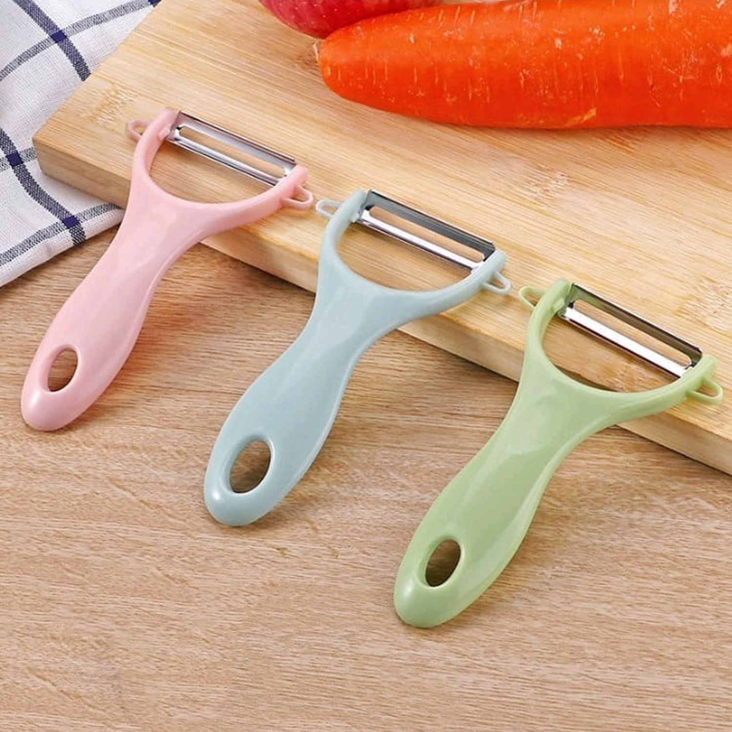 Ergonomic green plastic vegetable peeler with a durable stainless steel blade.