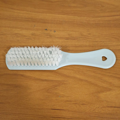 Close-up of ergonomic handle and bristles on handheld cleaning brush