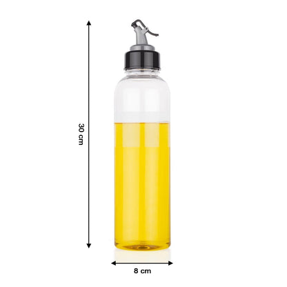 Hand pouring oil from the 1 litre transparent plastic oil dispenser with precise control.