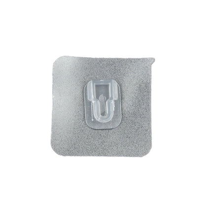 GlimmerHome transparent adhesive hook discreetly blending into a white wall.