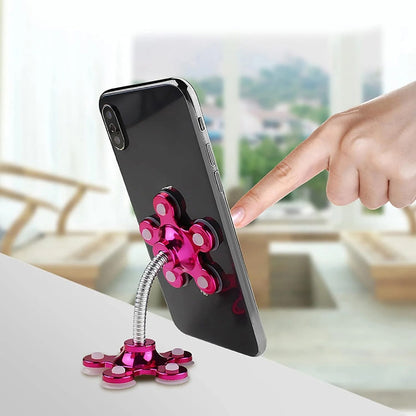 Driver's view of the universal sucker stand for phones mounted on a car dashboard.