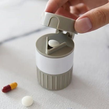 Opened Organivo medicine cutter revealing the pill cutting blade and storage areas.