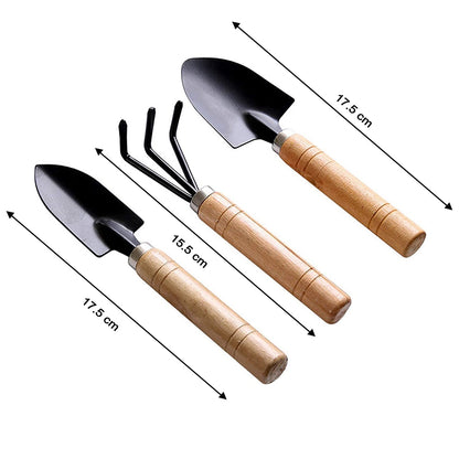 All three small gardening tools: a hand cultivator, trowel, and garden fork.