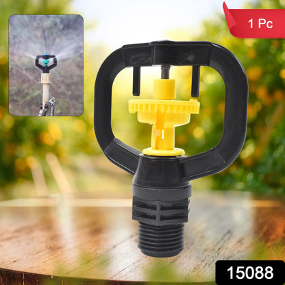 Rotating sprinkler nozzle effectively watering a lush green garden.