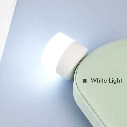 A bright USB bulb providing ambient light for a desk setup in an office environment.