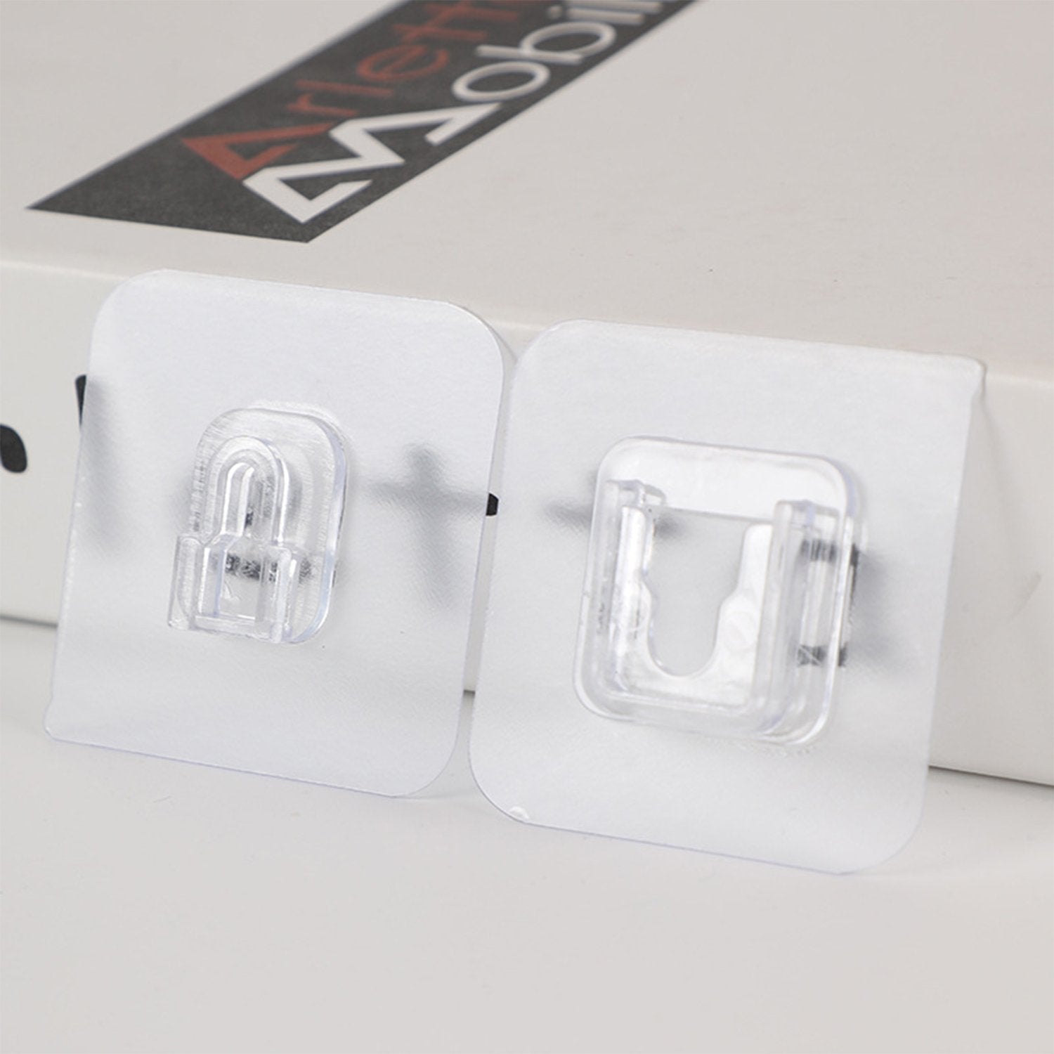 A pack of 20 GlimmerHome heavy-duty adhesive wall hooks shown for drill-free home organization.