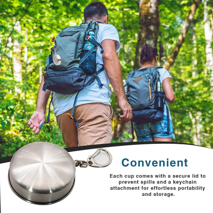 Stainless steel folding camping cup laid out with outdoor equipment.