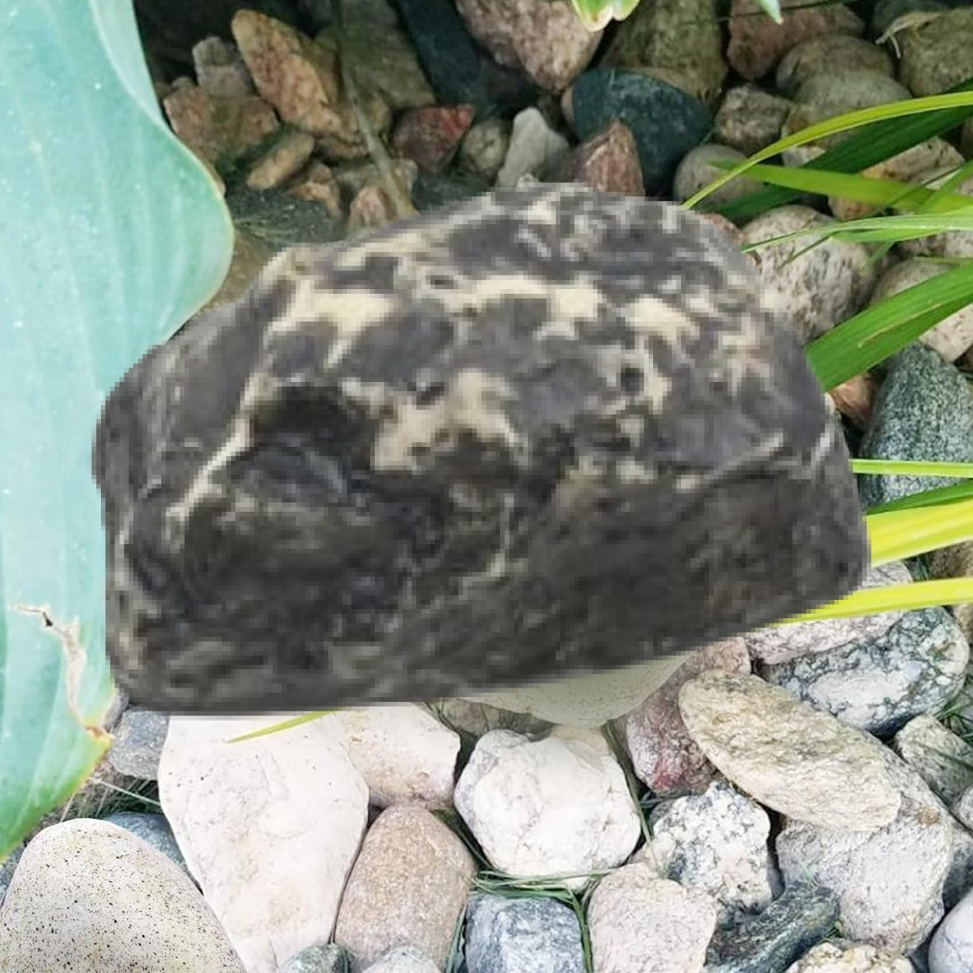 Open fake rock key hider displaying the slot designed for a standard house key.
