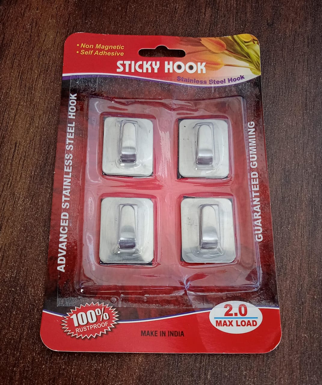 Heavy-duty self-adhesive wall hooks securely attached to a bathroom wall.