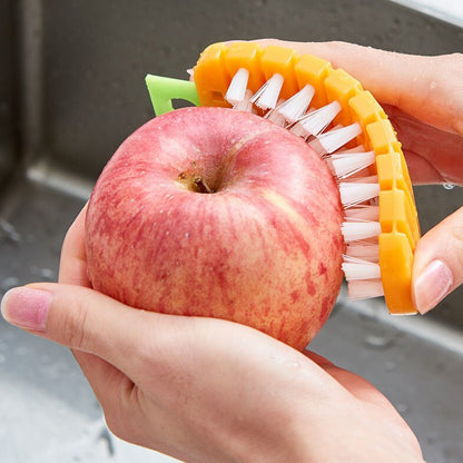 Side profile of the unique carrot-shaped vegetable scrubbing brush.