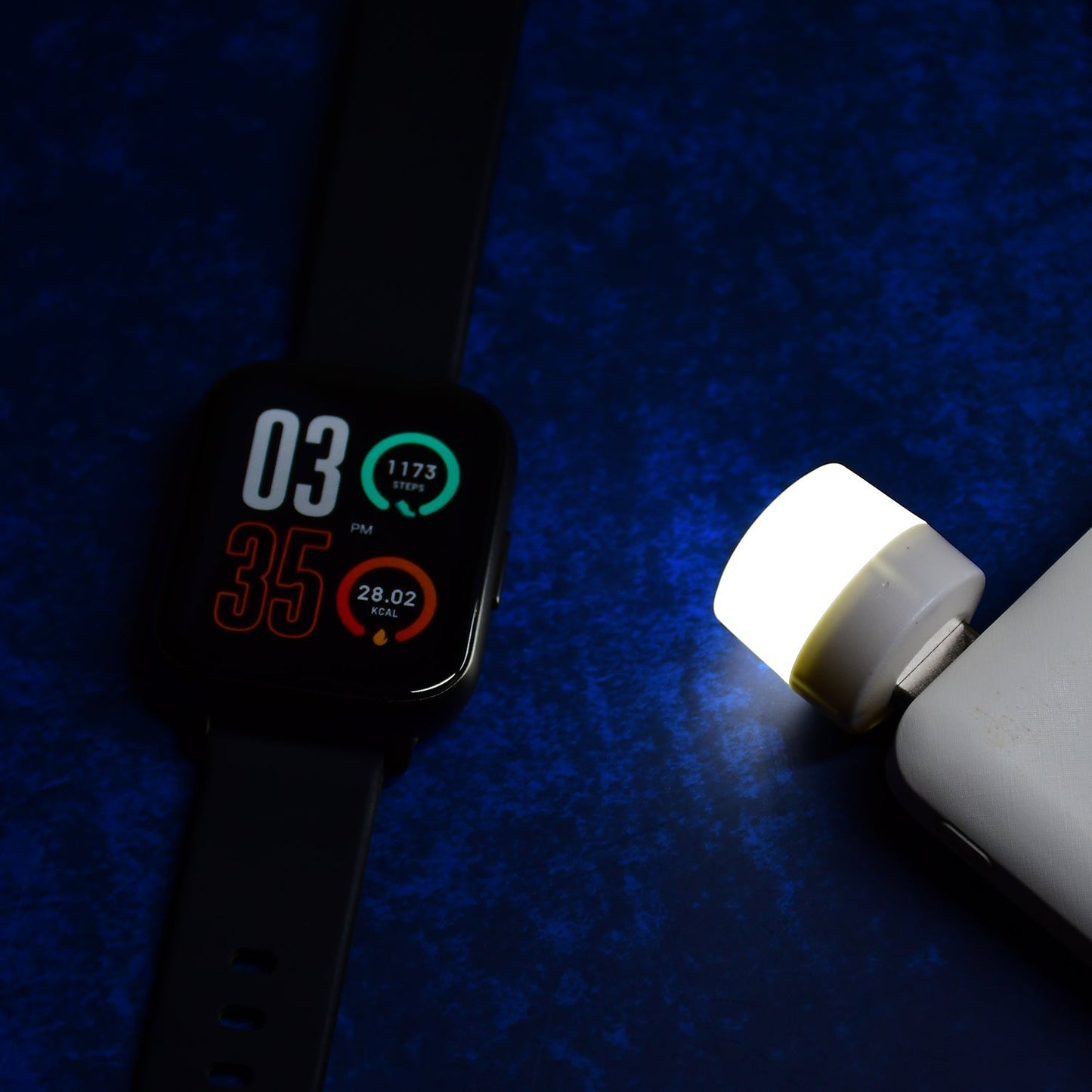 The portable LED lamp providing a soft glow next to a computer setup.