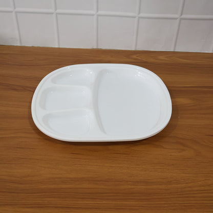 Plastic compartment plate in use with Indian meal served in sections