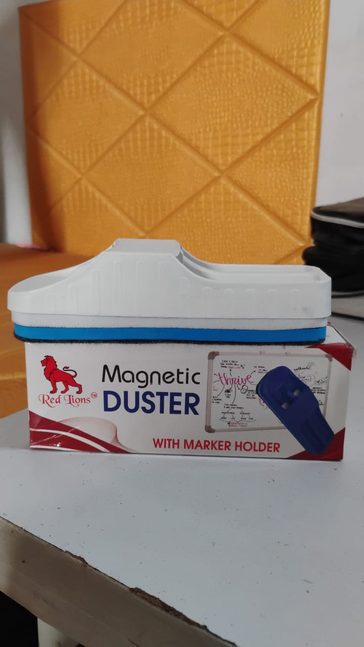 Magnetic board duster being used to clean a whiteboard in a school classroom.