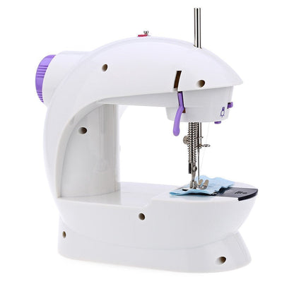 Close-up of the mini sewing machine's needle and thread for fabric stitching.