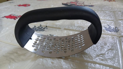 Side view of the GripChef garlic press, showcasing its sleek and compact form.