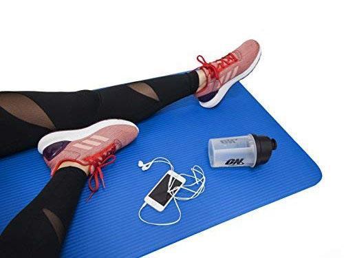 Athlete performing a yoga pose on the spacious, non-slip fitness mat.