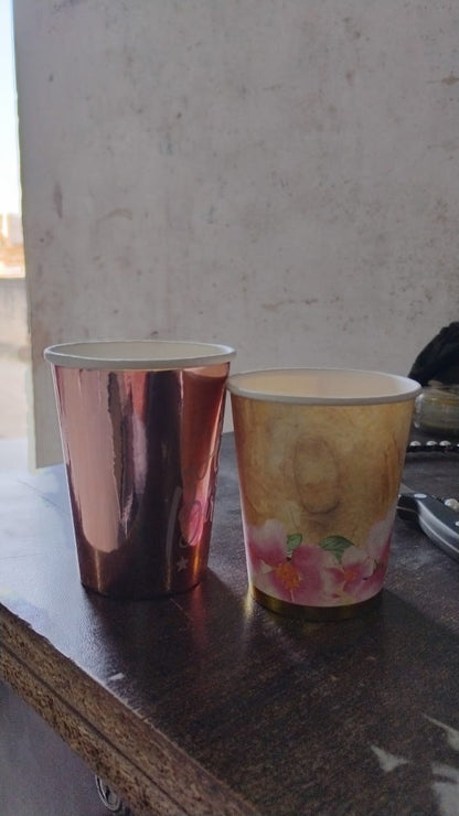 Overhead view of disposable paper cups, emphasizing their vibrant and appealing designs.