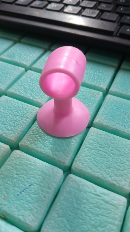 Mini silicone door stopper demonstrating multiple uses