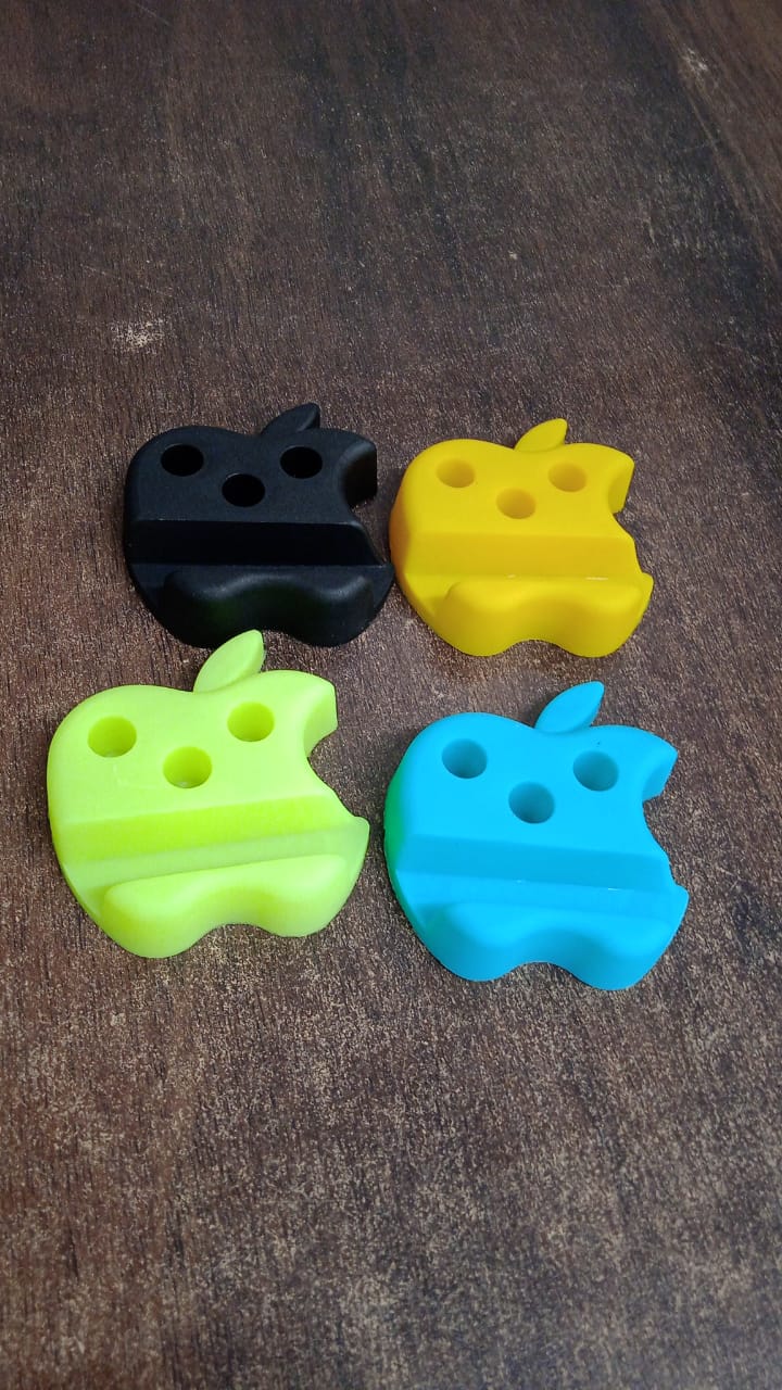 Multi-functional apple-shaped mobile stand with pen holder holding smartphone and pens