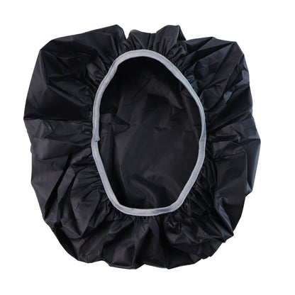 A black rain cover with a light gray elastic rim is spread open, showing its interior.