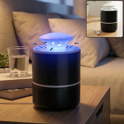 A black and white Mosquito Killer Lamp with a blue light on a wooden nightstand, with a glass of water and a book nearby.