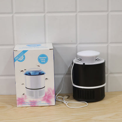 A black and white Mosquito Killer Lamp next to its product box, both on a wooden surface against a white tiled wall.