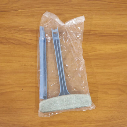 Close-up of the dual-sided brush head on the window mesh cleaning tool.