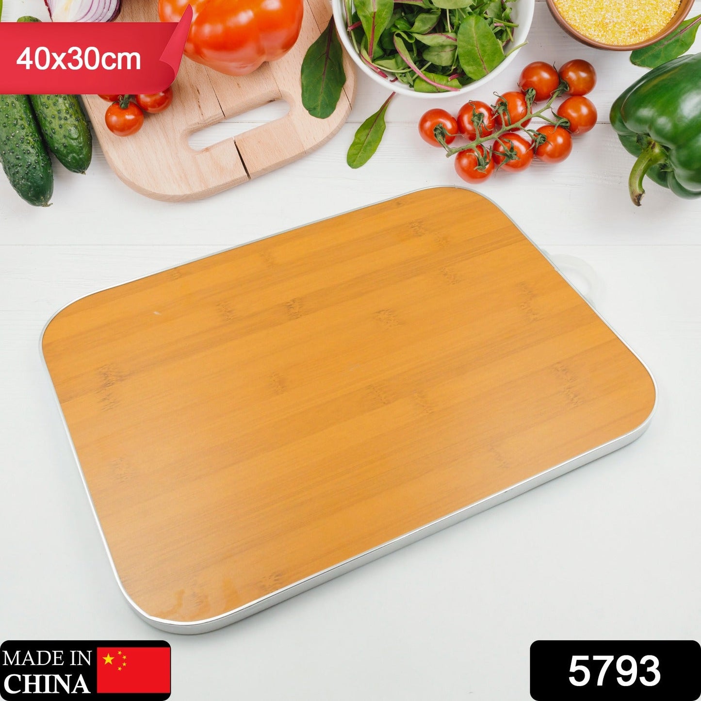 Comparison shot of a sleek bamboo cutting board next to a steel board.